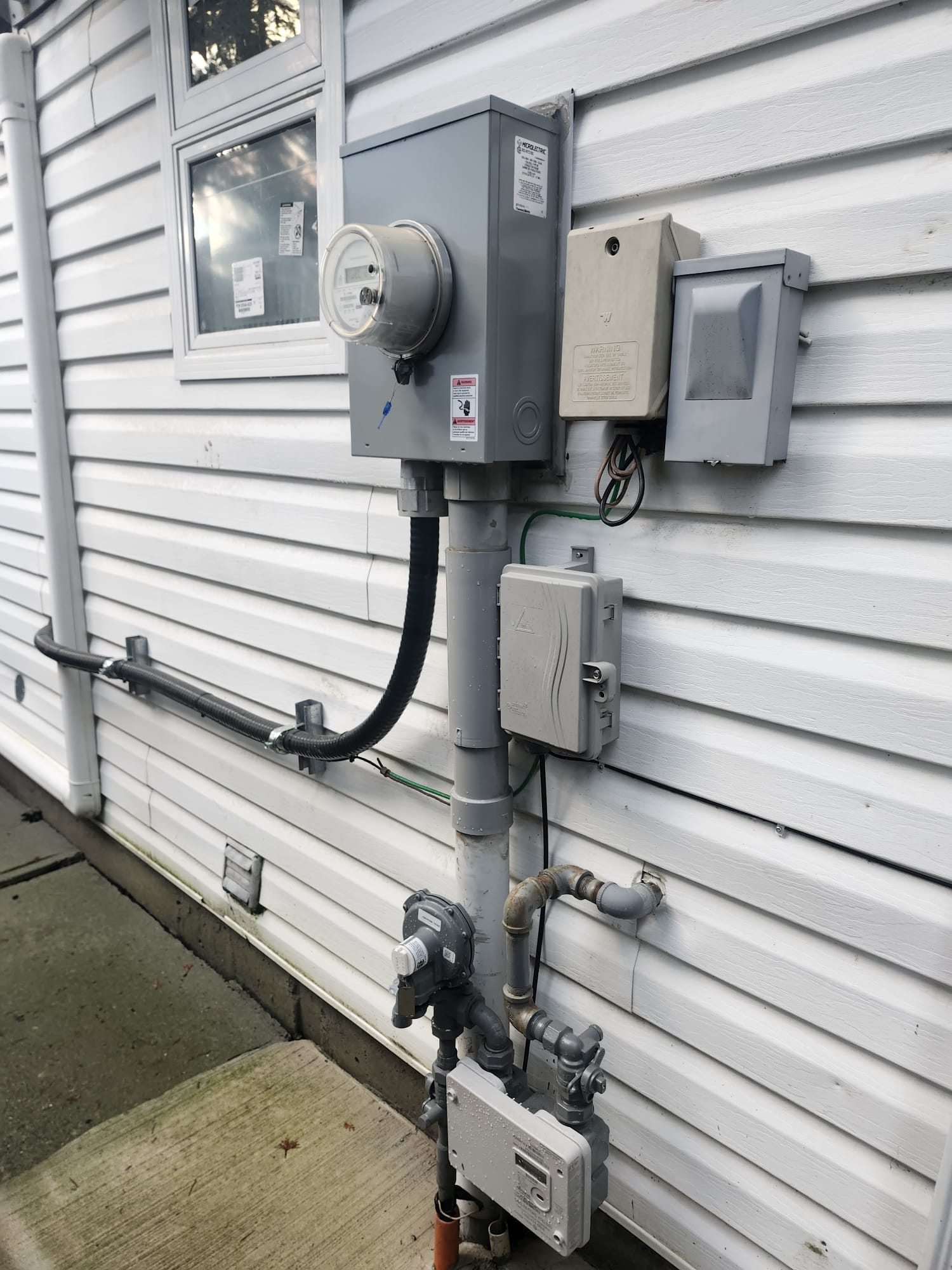 Electrical panel and meters mounted on a building exterior