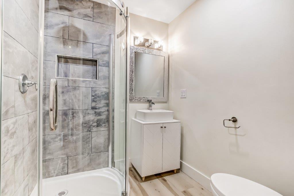 Bathroom with shower, sink, and toilet