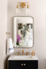 Bathroom vanity with mirror, sink, and decorative elements.