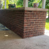 Brick porch column with concrete cap on residential home exterior