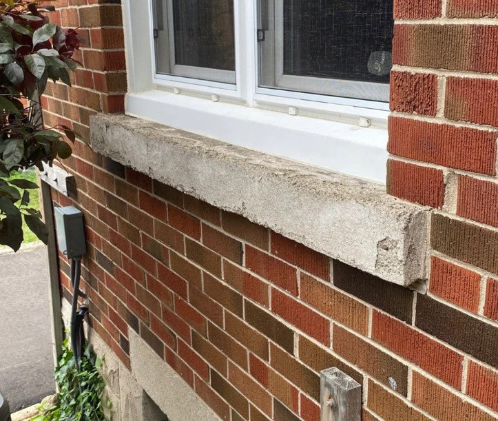 Brick exterior wall with concrete window sill and installed window