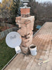 Chimney repair on a roof with a Bell device in the foreground