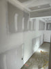 Interior drywall installation and finishing with joint compound during residential home construction project
