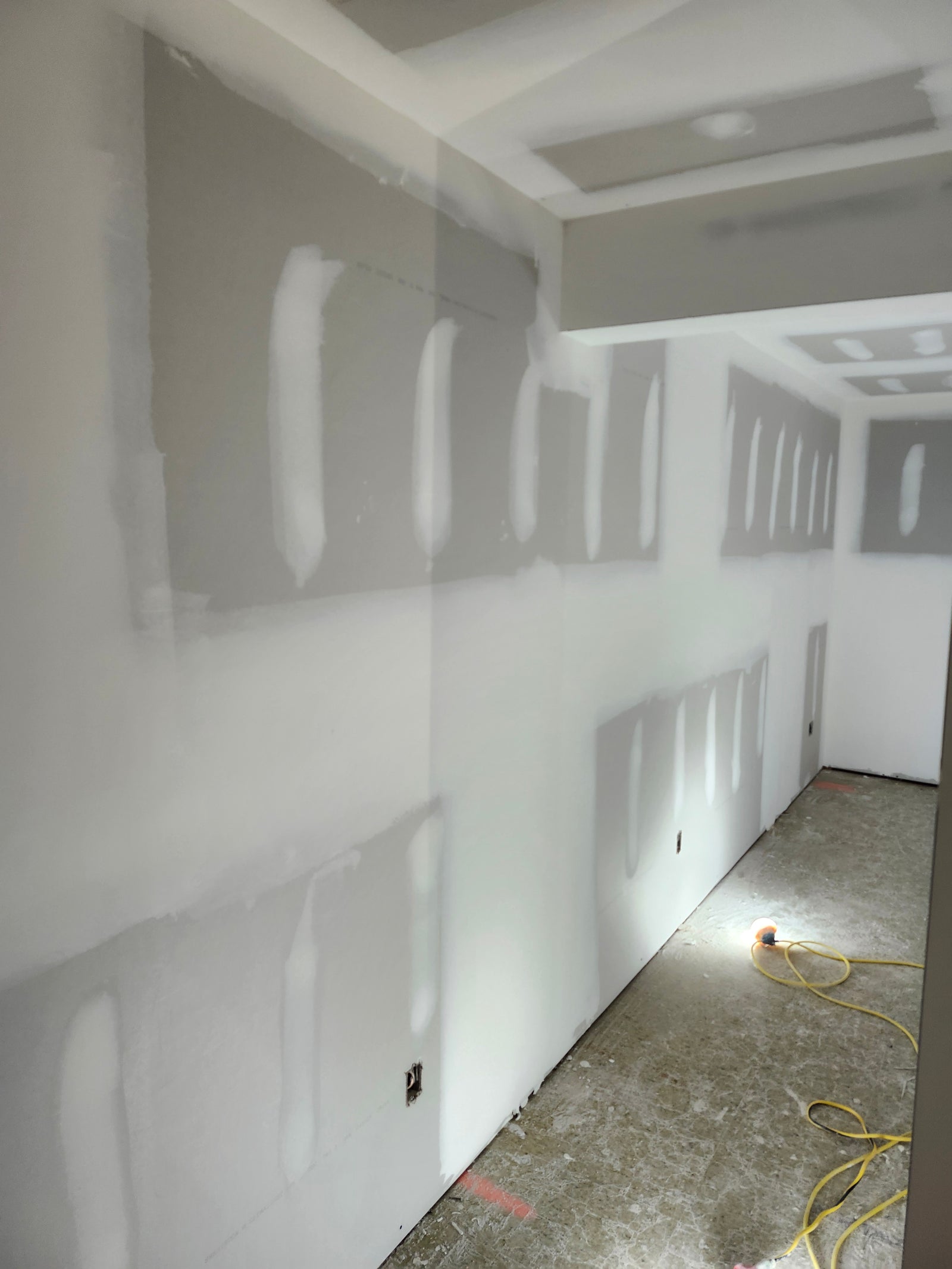 Interior drywall installation and finishing with joint compound during residential home construction project