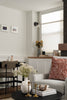 Living room with a gray sofa, coffee table, and decorative items.
