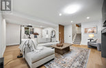 Modern living room with a sectional sofa, coffee table, and decorative elements.