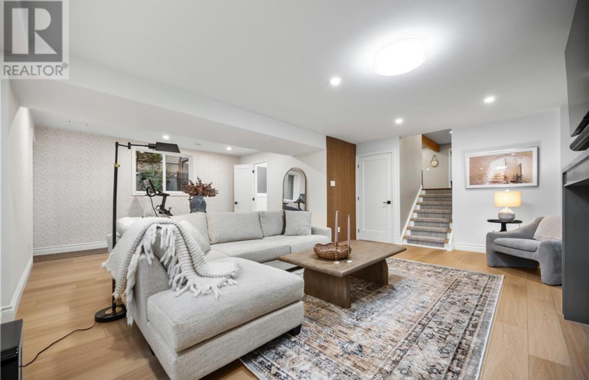 Modern living room with a sectional sofa, coffee table, and decorative elements.