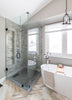 Modern bathroom with glass shower enclosure, freestanding bathtub, and large window.