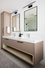 Bathroom vanity with two mirrors and a light fixture above.
