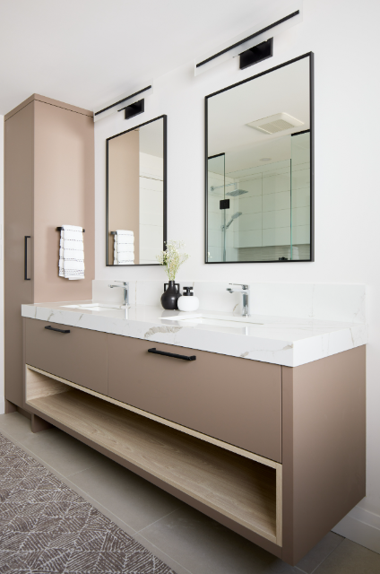 Bathroom vanity with two mirrors and a light fixture above.