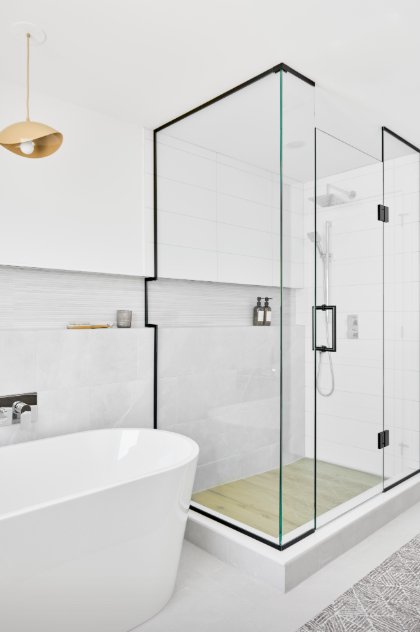 Modern bathroom with freestanding bathtub and glass shower enclosure.