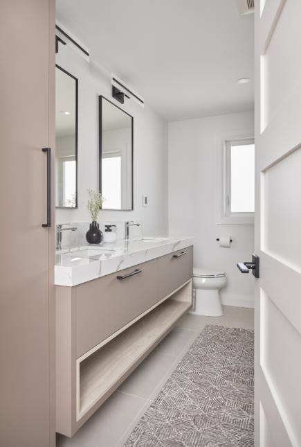 Modern bathroom with a vanity, mirror, and toilet.