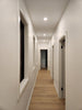 Ceiling with recessed lighting and air conditioning units in a modern interior setting.