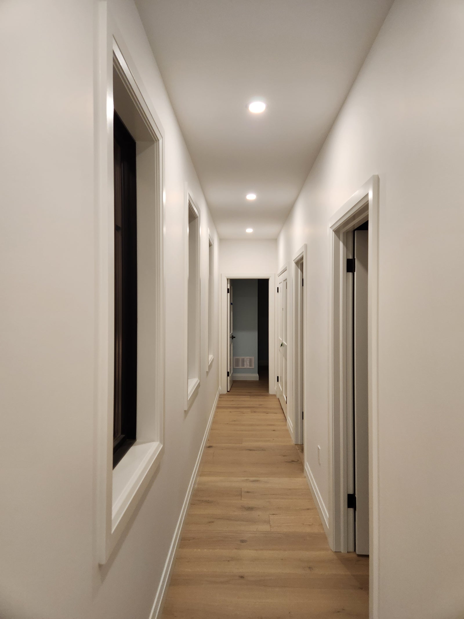 Ceiling with recessed lighting and air conditioning units in a modern interior setting.
