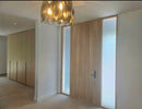 Modern interior with wooden paneling and a chandelier.