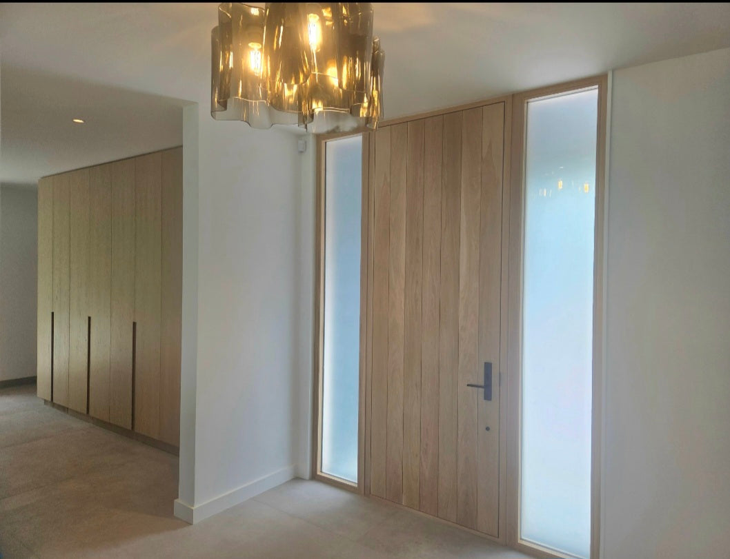 Modern interior with wooden paneling and a chandelier.