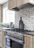 Modern kitchen with stainless steel stove and brick wall