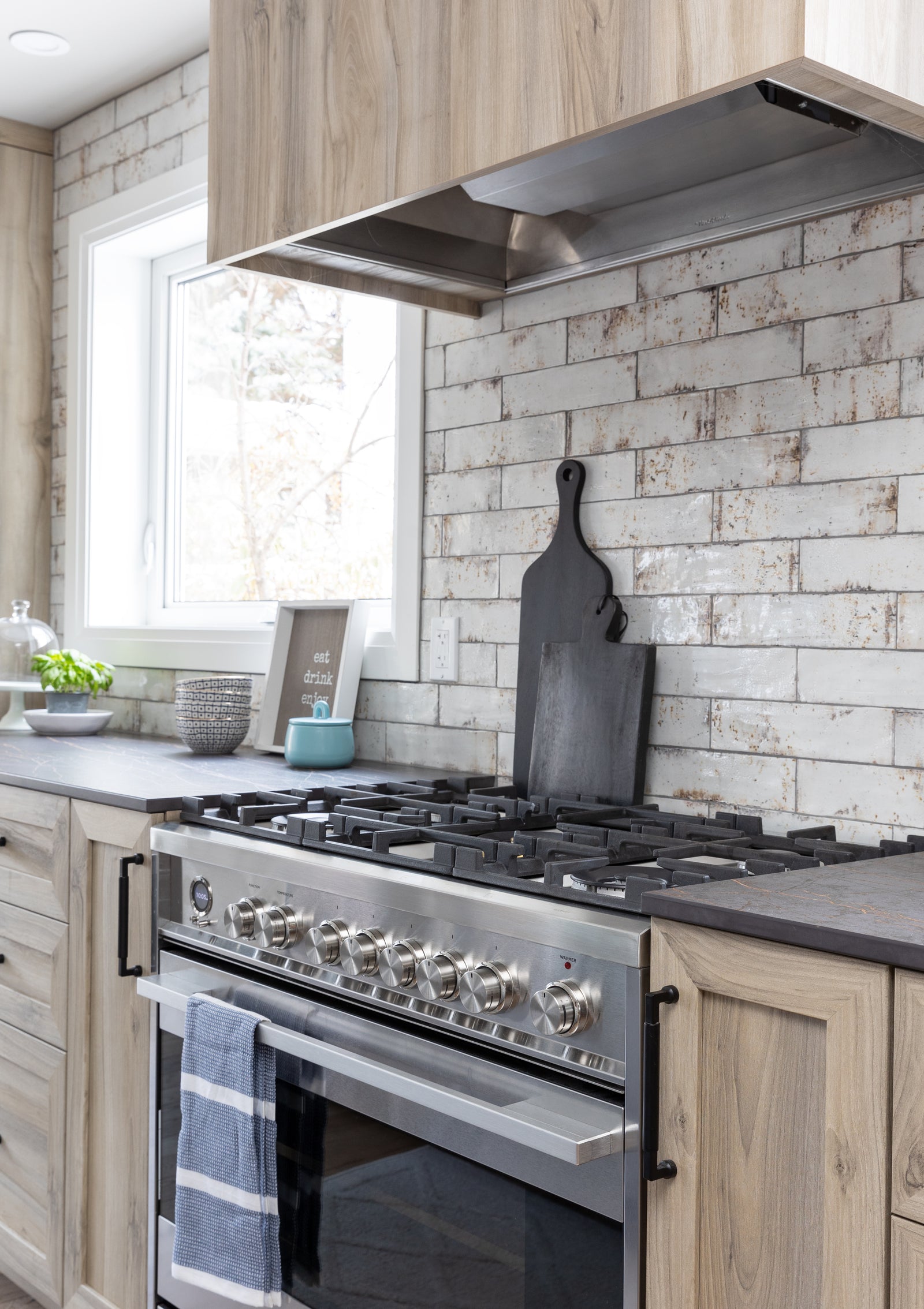 Modern kitchen with stainless steel stove and brick wall
