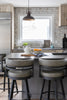 Modern kitchen with island, stools, and decorative elements.
