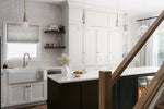 Modern kitchen with white cabinets, marble countertop, and wooden staircase.