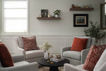 Contemporary living room design with gray upholstered sofa, red decorative throw pillows, and stylish coffee table in residential home