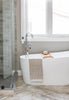 Modern bathroom with a freestanding bathtub, shower, and large window.