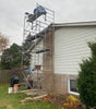 Scaffolding set up against residential house during exterior construction work
