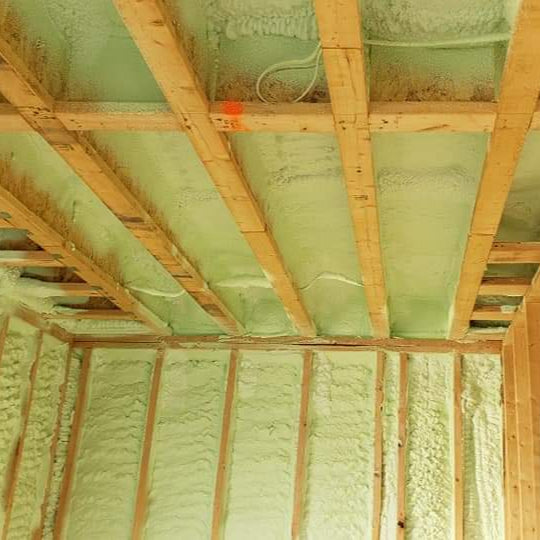 Spray foam insulation applied to the walls and ceiling of a construction site or existing building.
