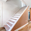 Staircase with wooden steps and white risers in a home interior.