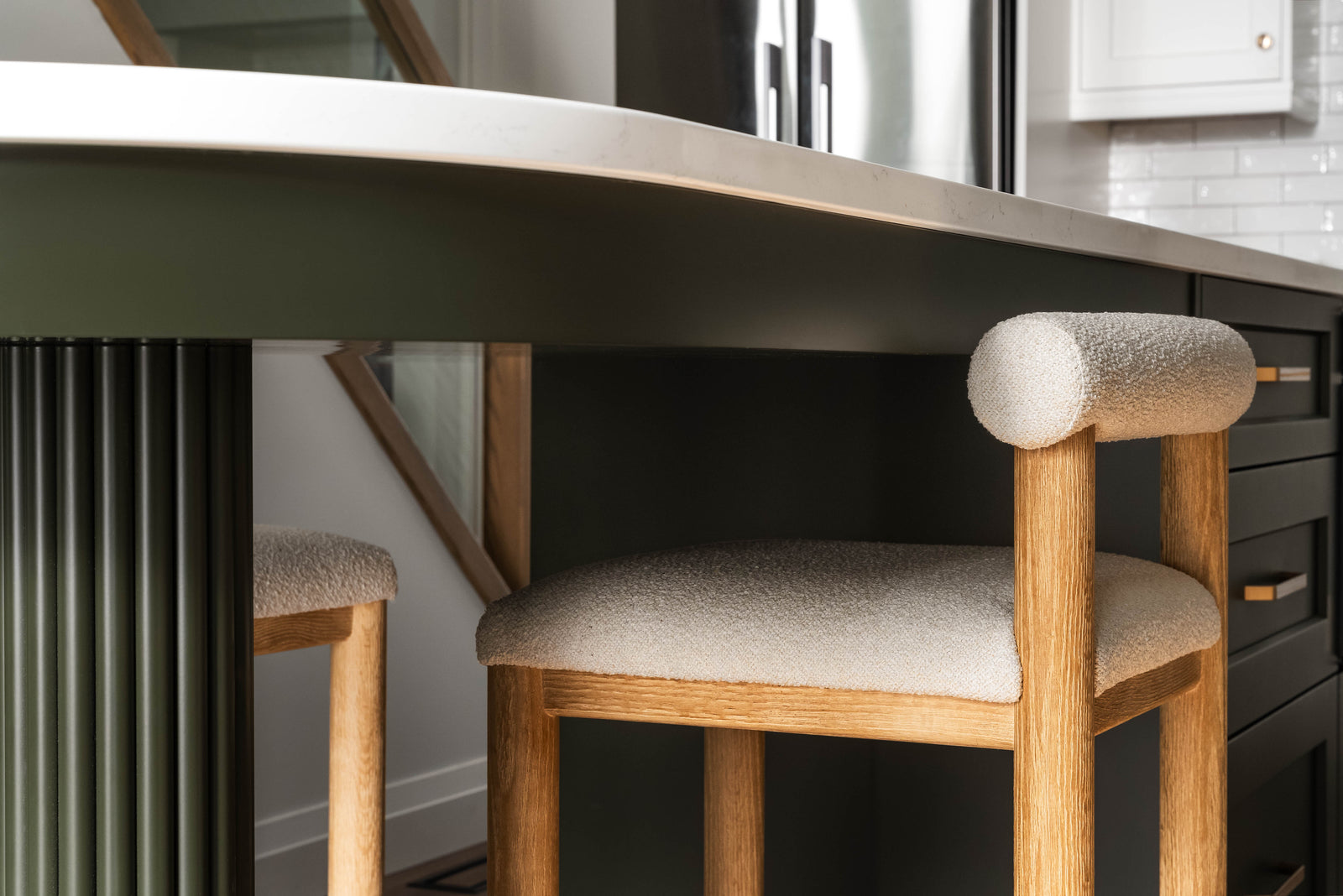 Wooden bar stools with cushioned seats in a kitchen setting